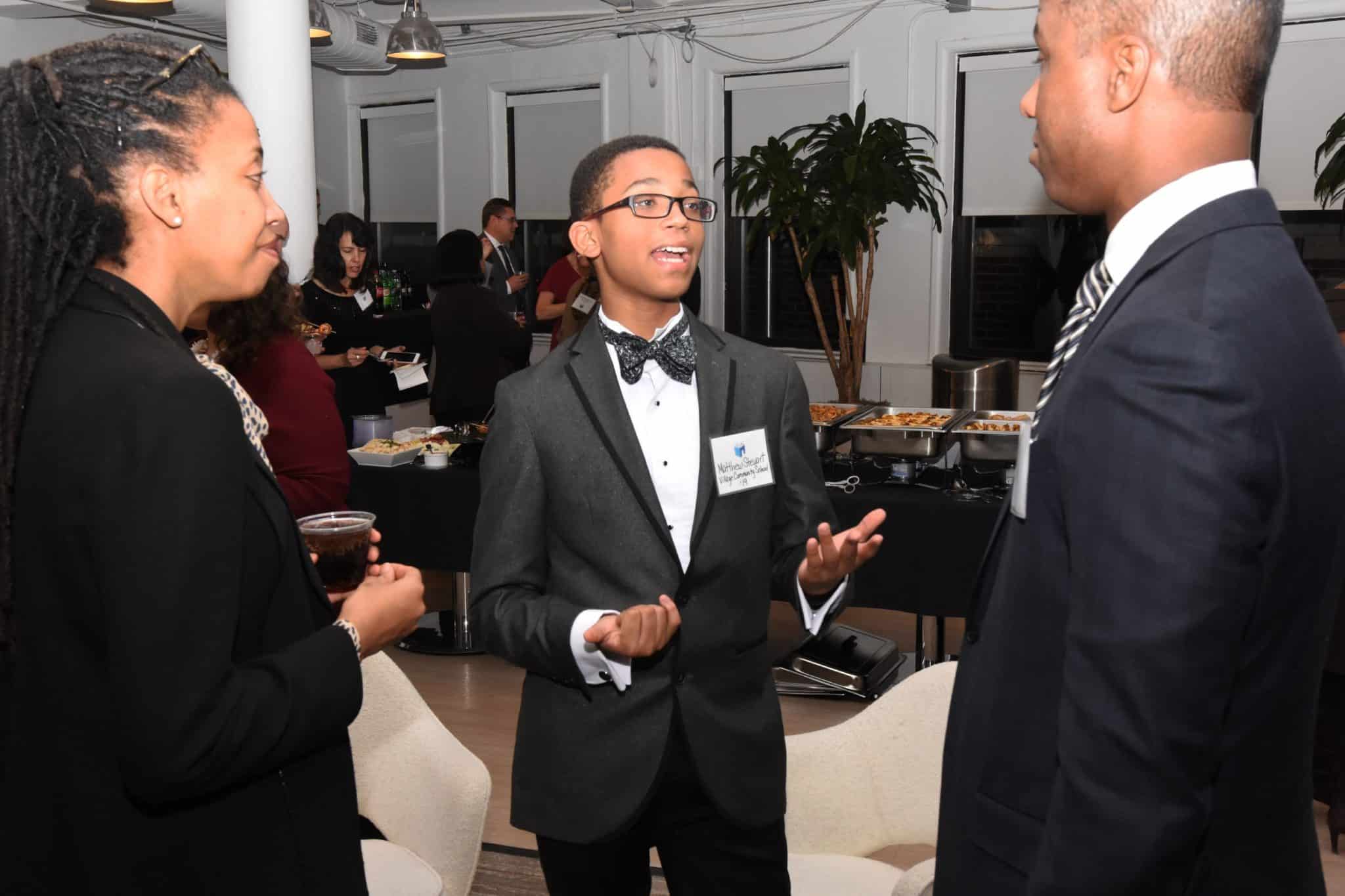 Scholar talking with attendees at Builde A Dream event in 2017